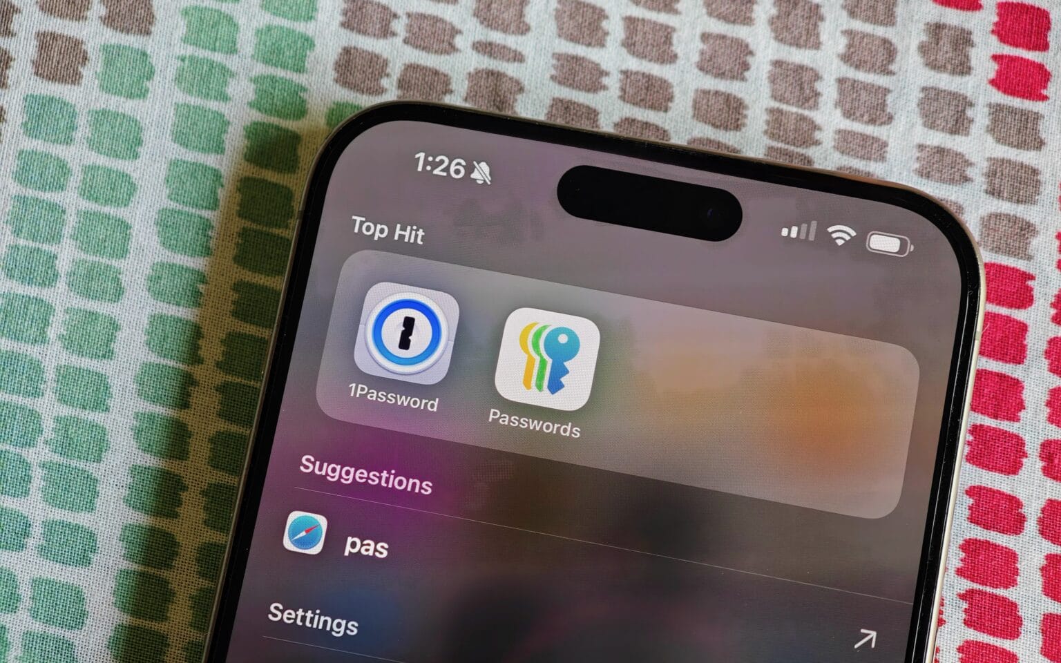 1Password and Apple Passwords in Spotlight on iPhone 15 Pro Max