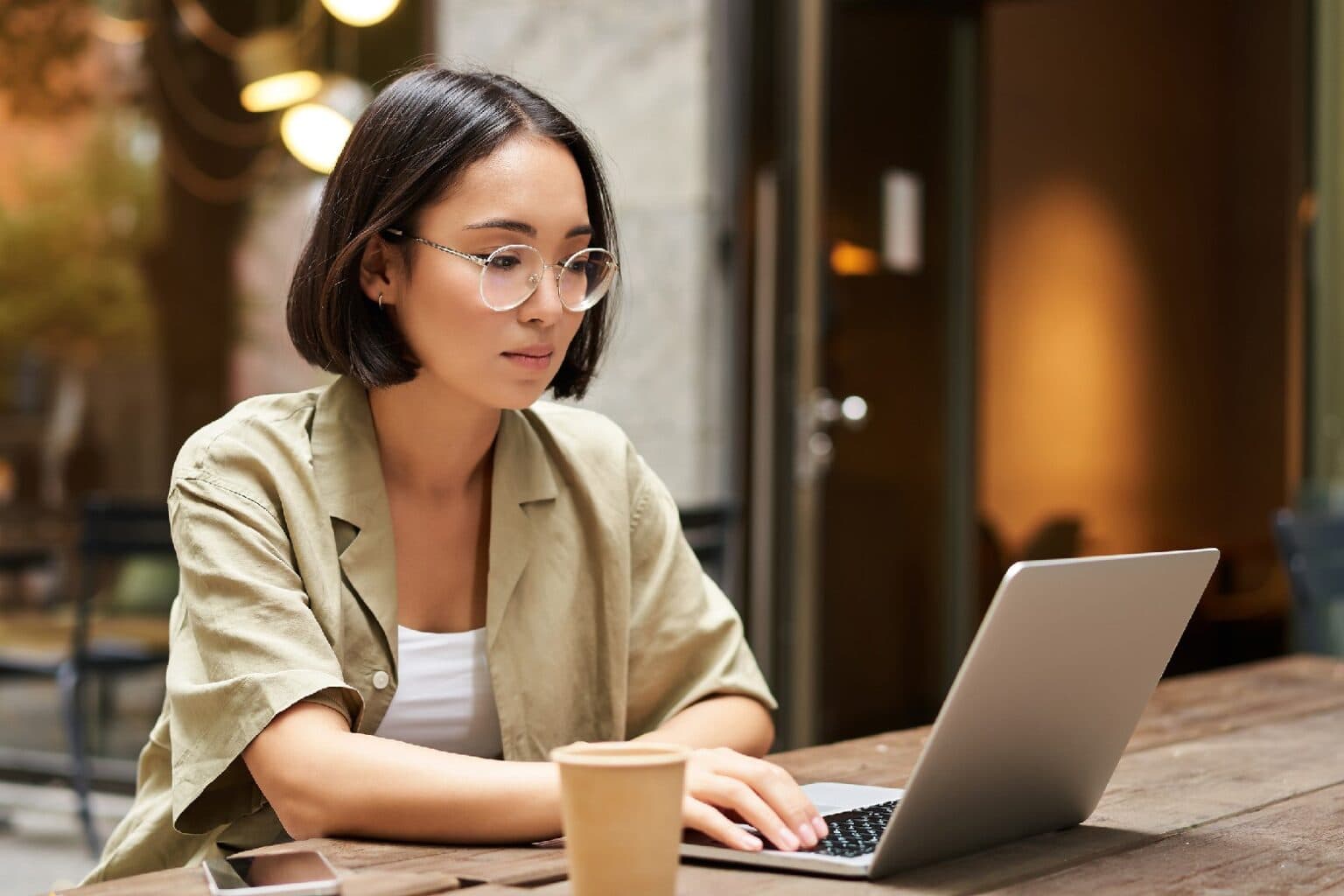 Product photo of a woman looking at computer running the Mind2Matter's AI Articles WordPress plugin to create SEO-friendly blog posts.