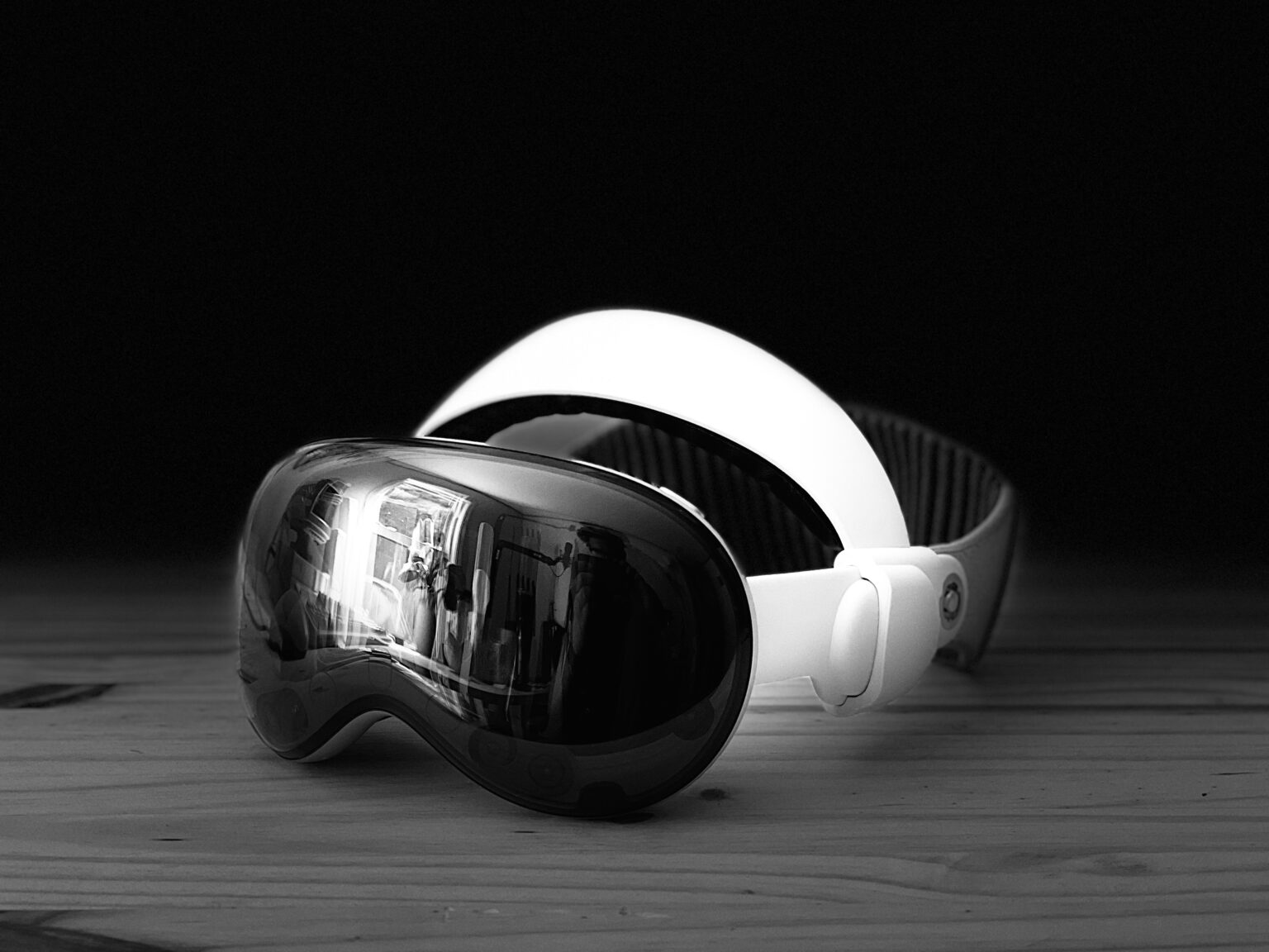 Black and white studio lit portrait photo of the ANNAPRO Comfort Head Strap on a Vision Pro sitting on a pine surface