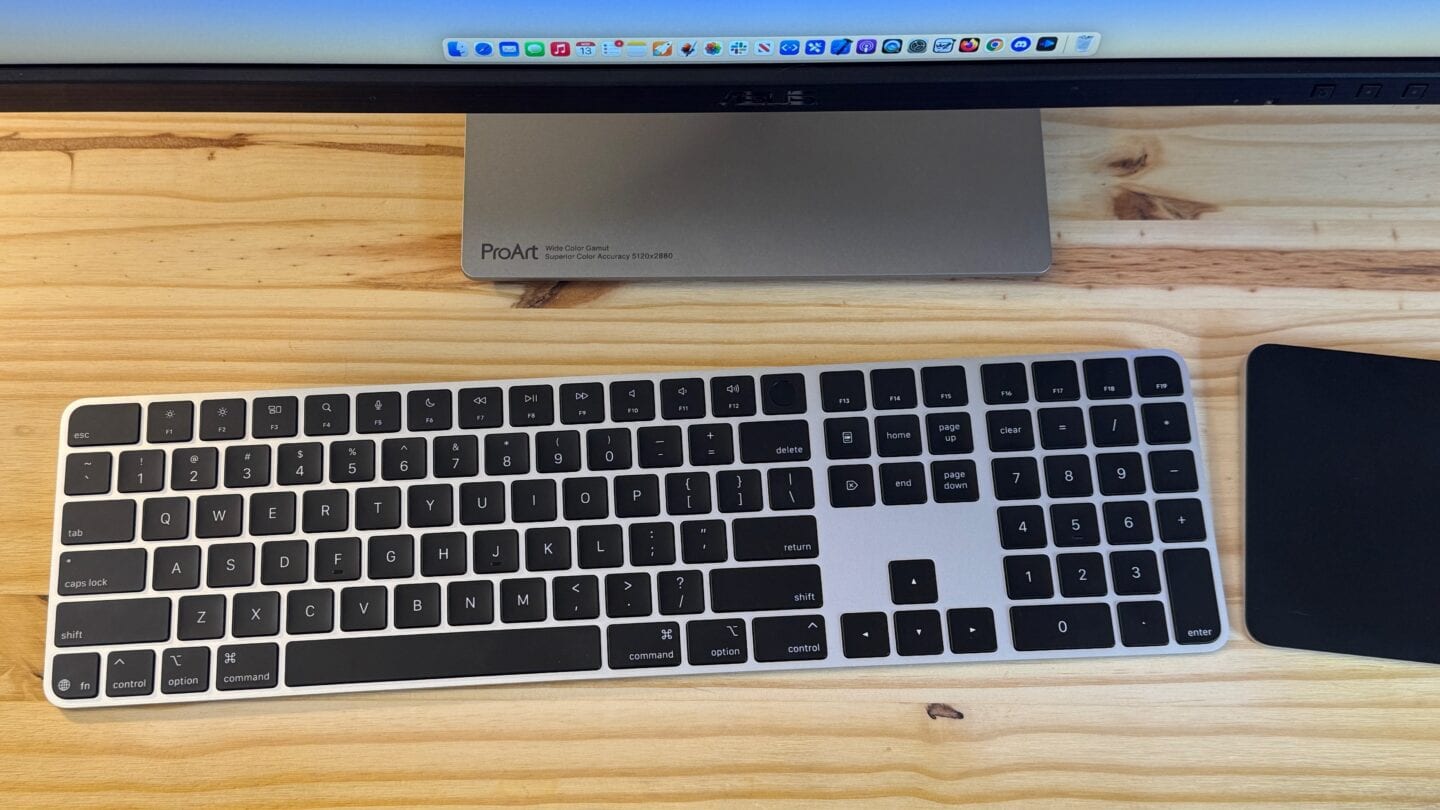 Black Magic Keyboard next to a Trackpad and display.