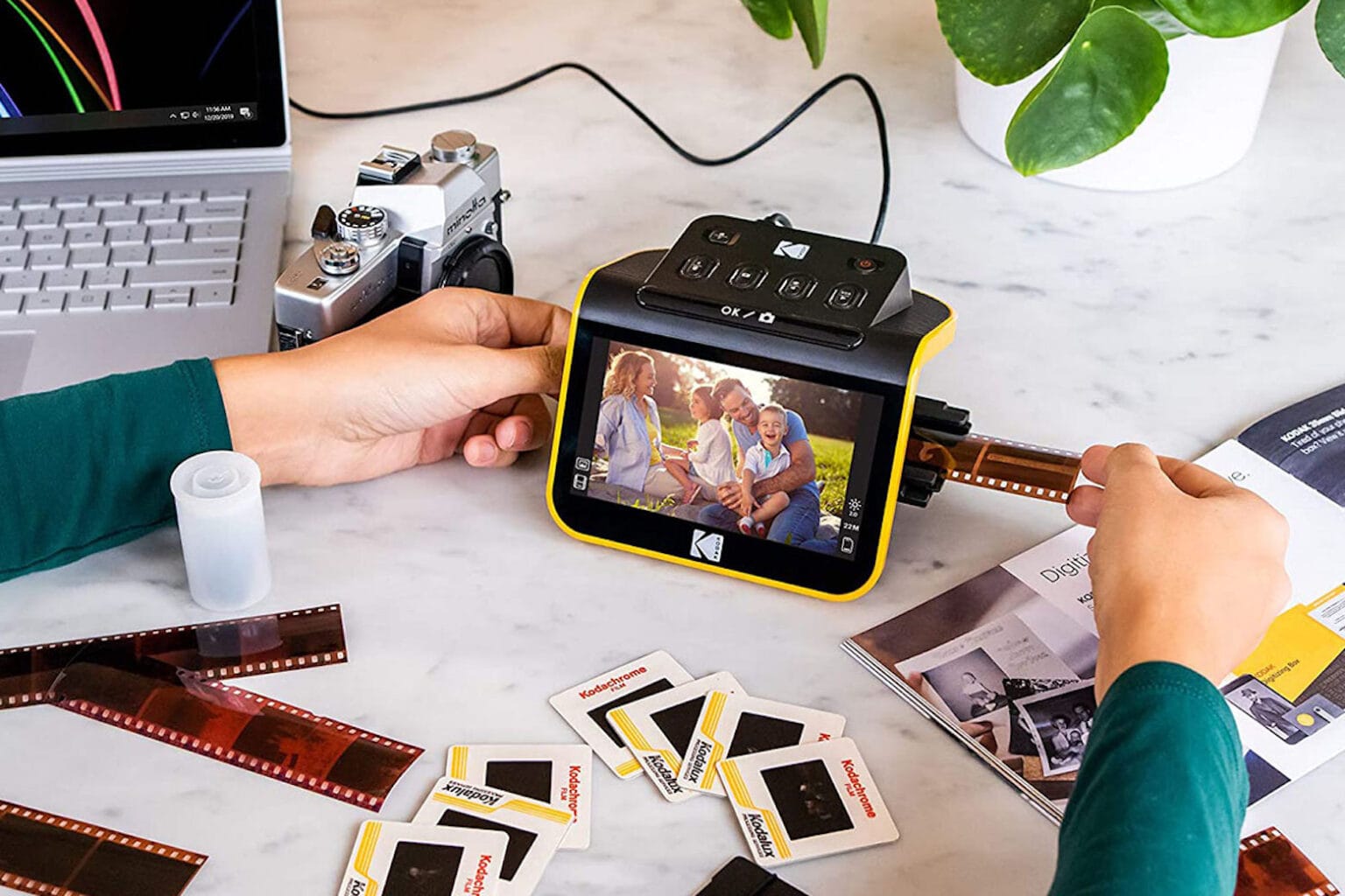 Product shot of a person using a Kodak Slide N Scan slide film scanner