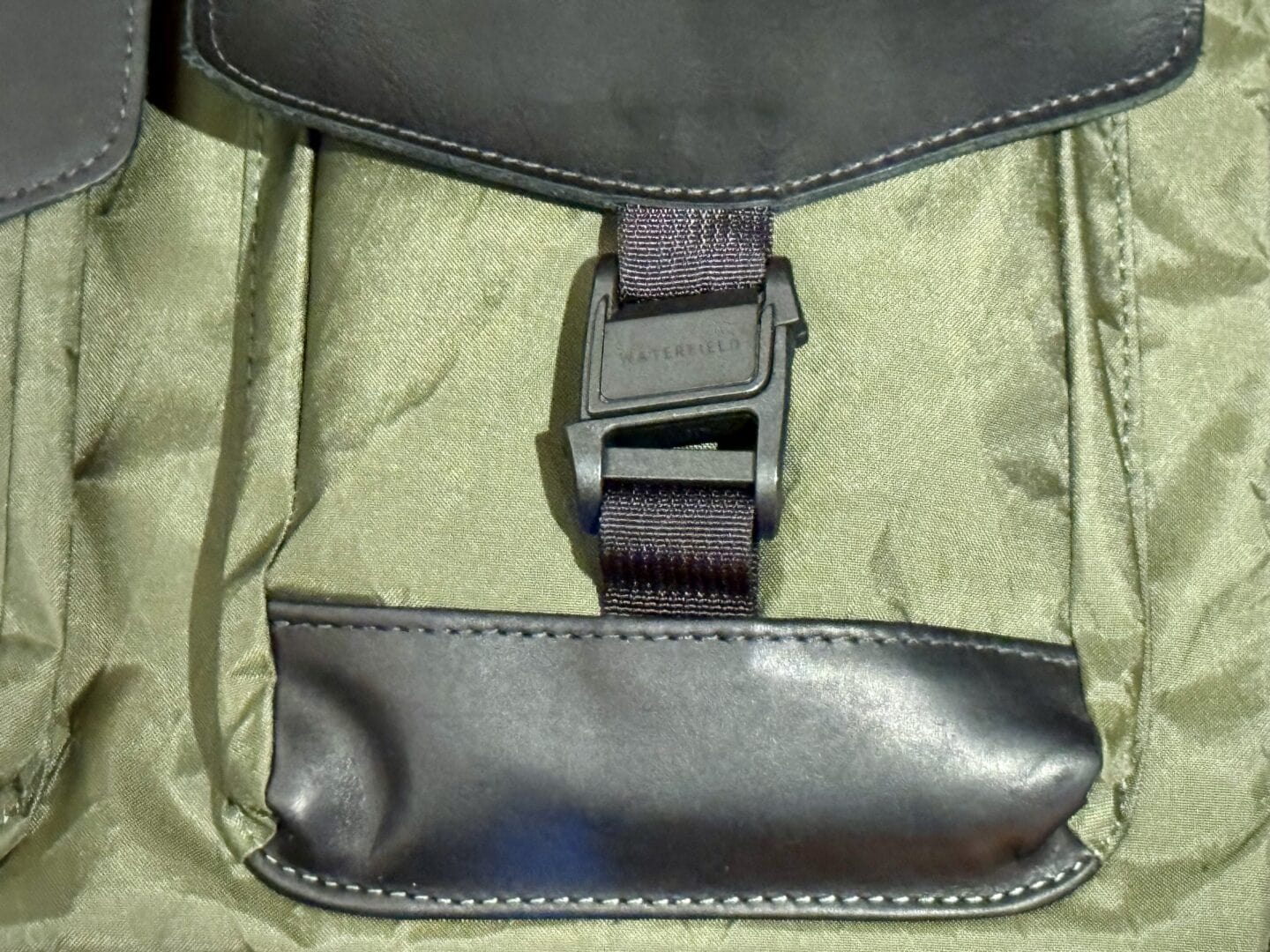 Close-up photo of Fidlock magnetic buckle on WaterField Designs X-Air Duffel bag.