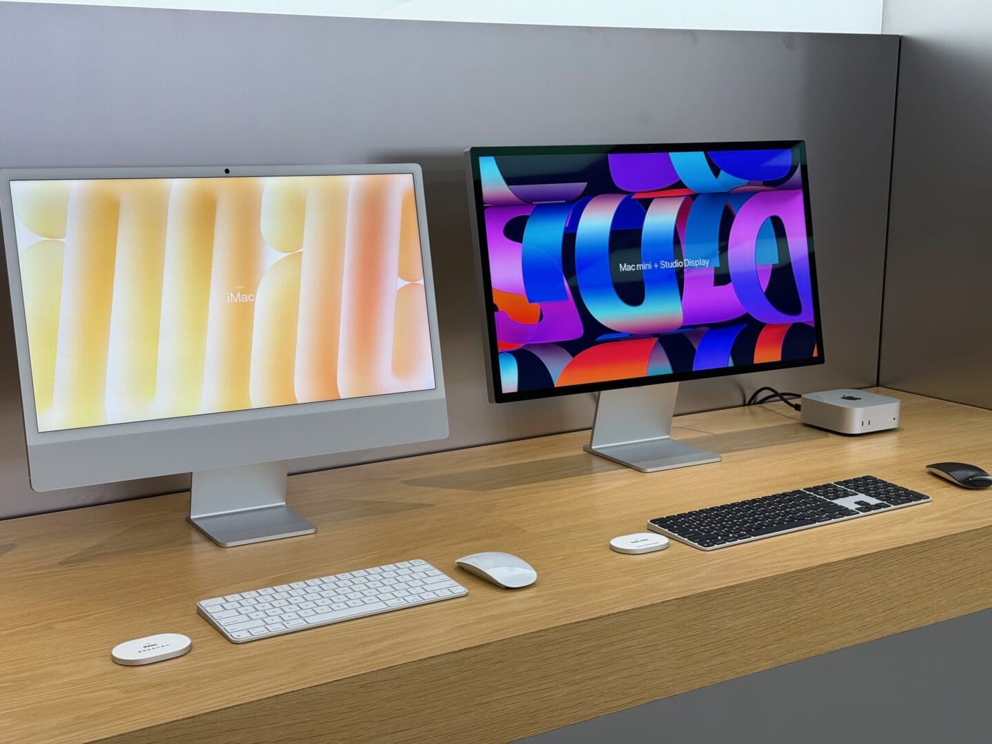 Silver iMac next to a Mac Studio and Apple Studio Display in an Apple Store.