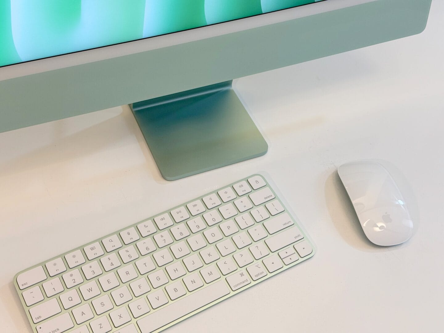 Close-up of the green Magic Keyboard and Magic Mouse