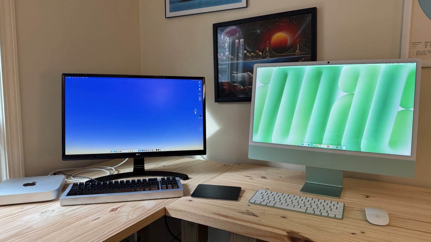 Mac mini setup with black display, keyboard and trackpad next to a green M4 iMac.