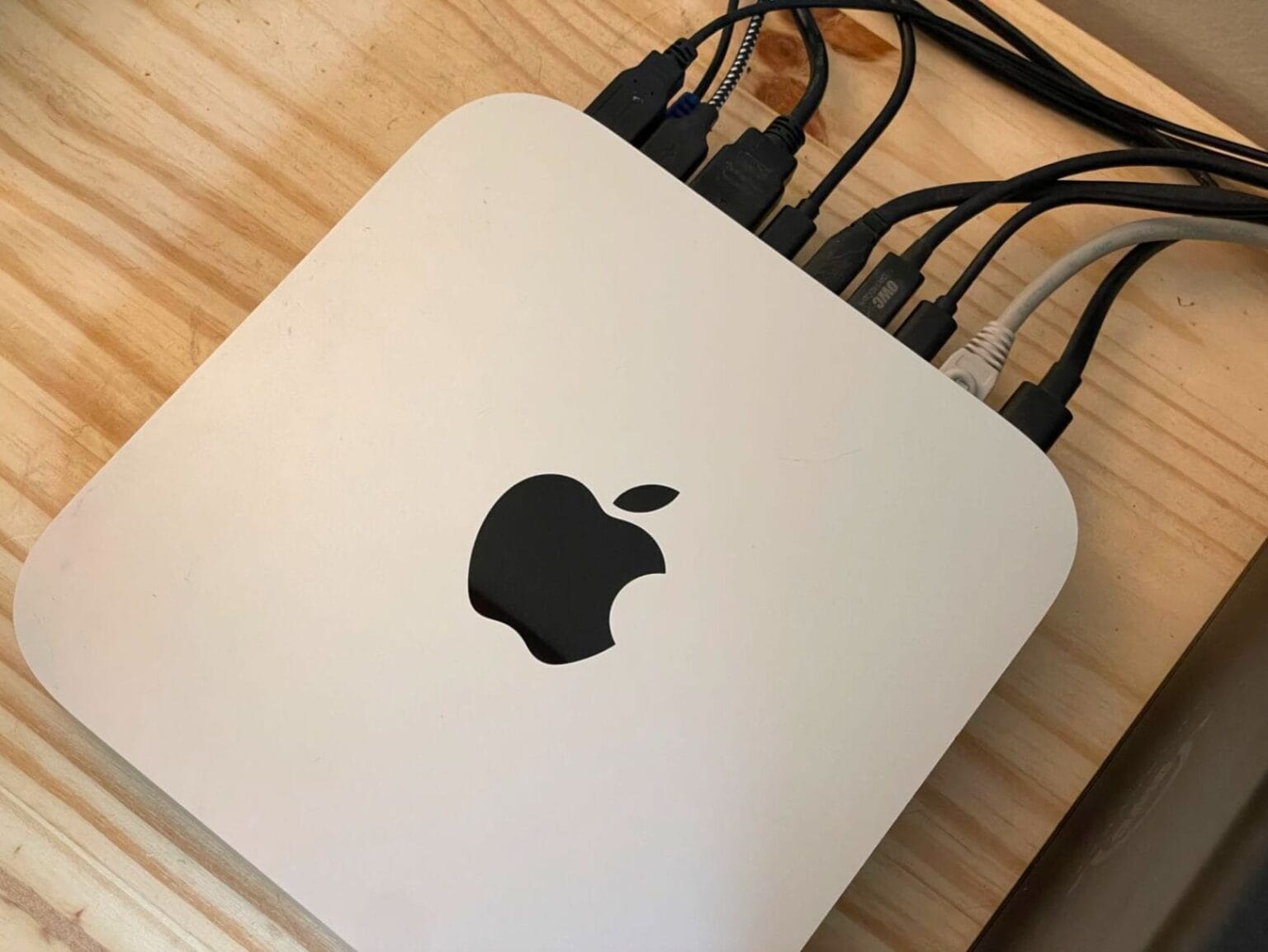 Top-down image of a Mac mini with a bunch of stuff plugged into the back