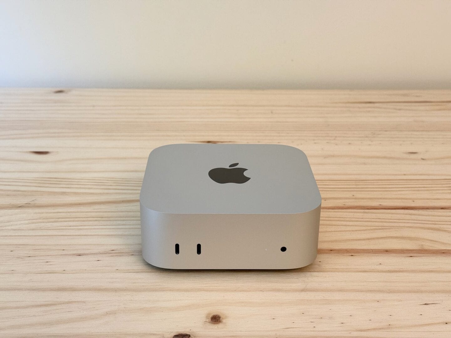 Mac mini M4 pictured from the front, on a table