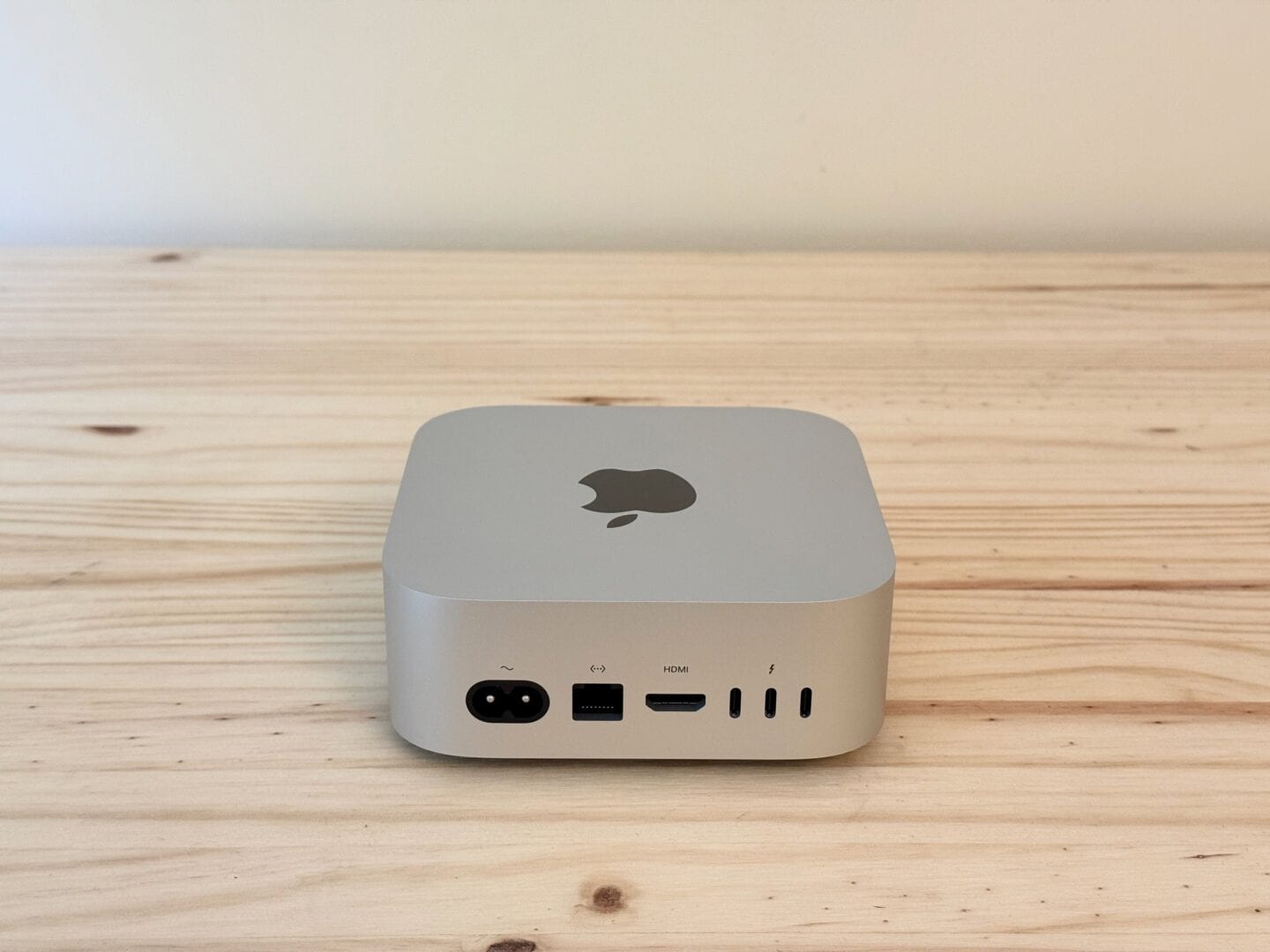 Mac mini M4 pictured from the rear, on a table