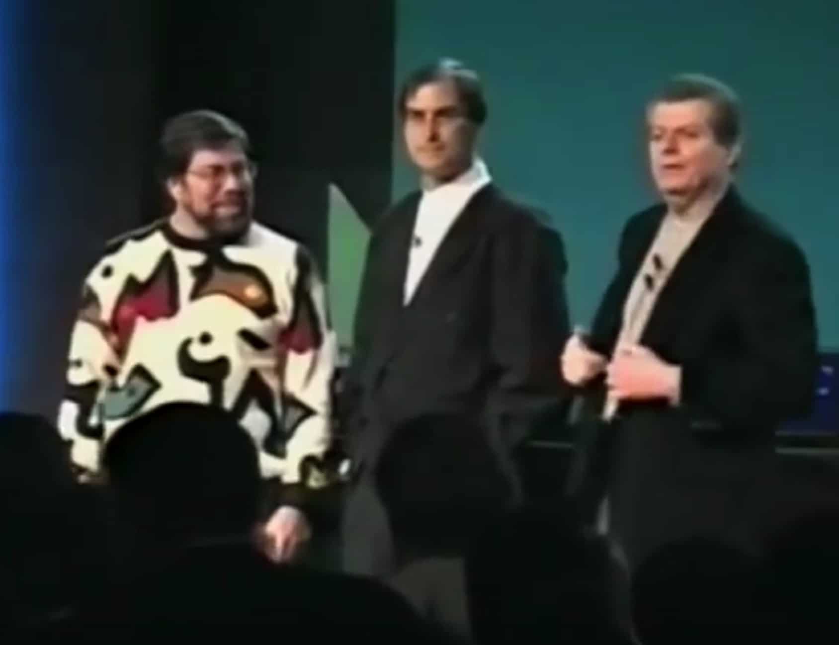 Photo of Steve Wozniak and Steve Jobs, joining Apple CEO Gil Amelio for an onstage reunion on January 7, 1997.