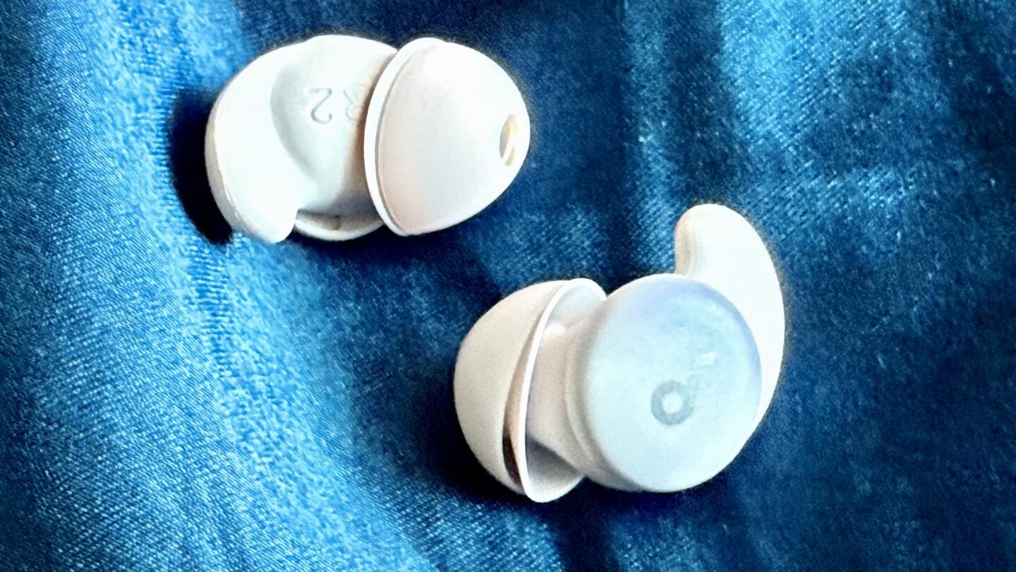 Photo of soundcore Sleep A20 sleep earbuds on a blue pillow case.