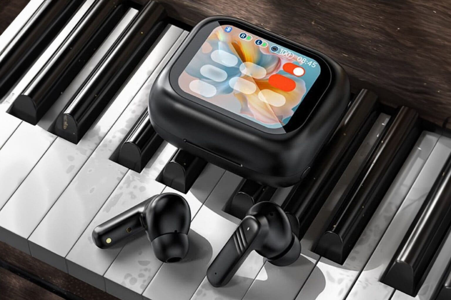 Product shot of black touchscreen earbuds that are an AirPods alternative, sitting on a piano keyboard